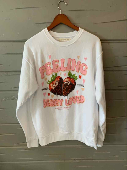 White crewneck sweatshirt with pink "Feeling Berry Loved" text and a graphic of strawberries and leaves.