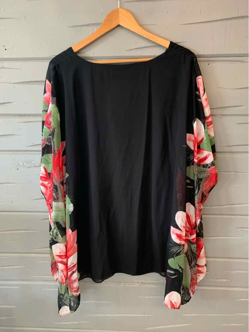 Black blouse with boat neckline and long floral print sleeves in red, white, and green tones.