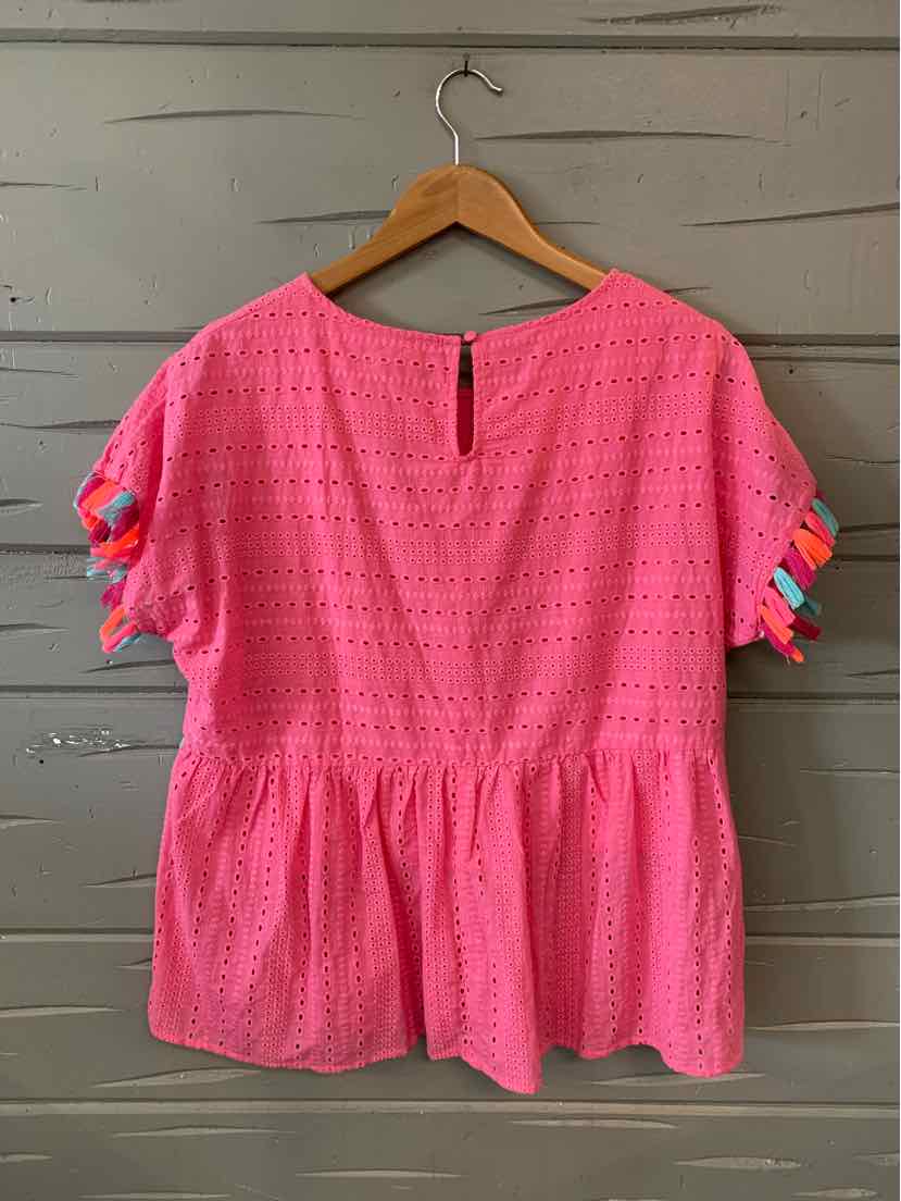Pink eyelet short-sleeve blouse with gathered waist and colorful ribbon accents on sleeves.