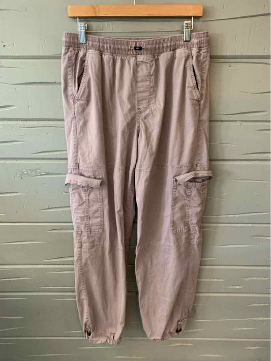 Mauve cargo pants with elastic waist, button fly, side pockets, and adjustable ankle cuffs in size medium.