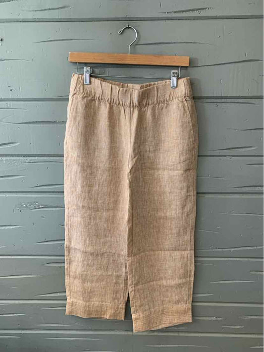 Sand-colored linen midi skirt with front slit and elastic waistband hanging on wooden hanger.