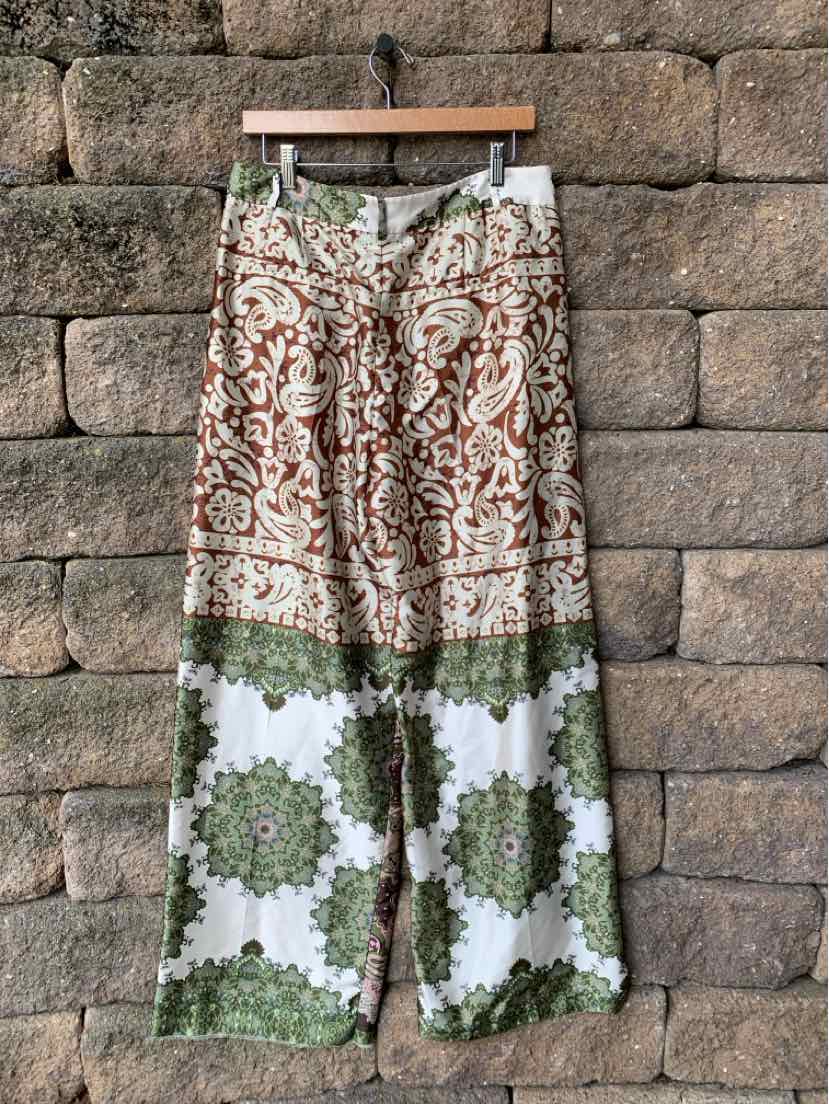 Wide-leg patchwork pants with green and brown botanical prints, lightweight fabric.