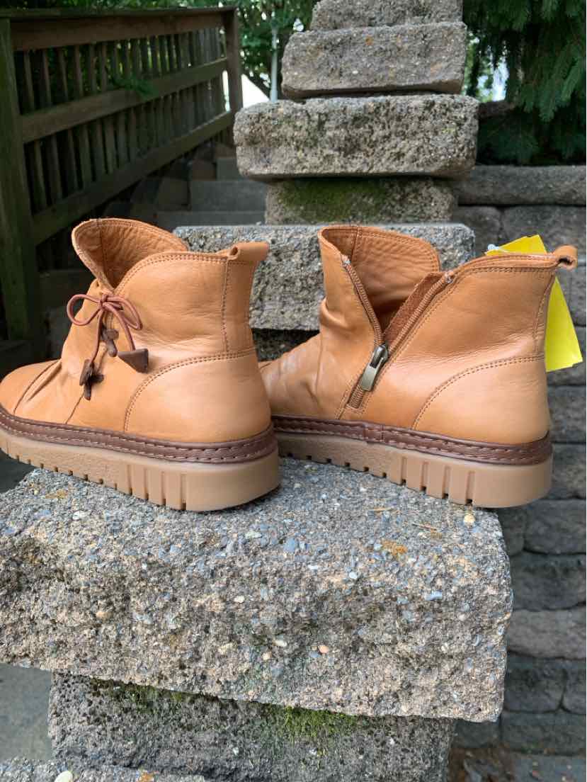 Tan leather ankle boots with side zipper and decorative tassels, flat rubber soles, size 39.