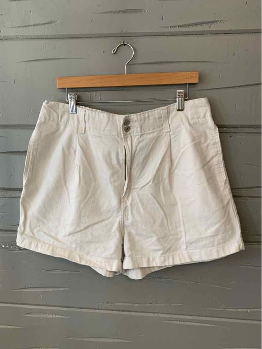 White denim shorts with front button and zipper closure, side pockets, and belt loops.