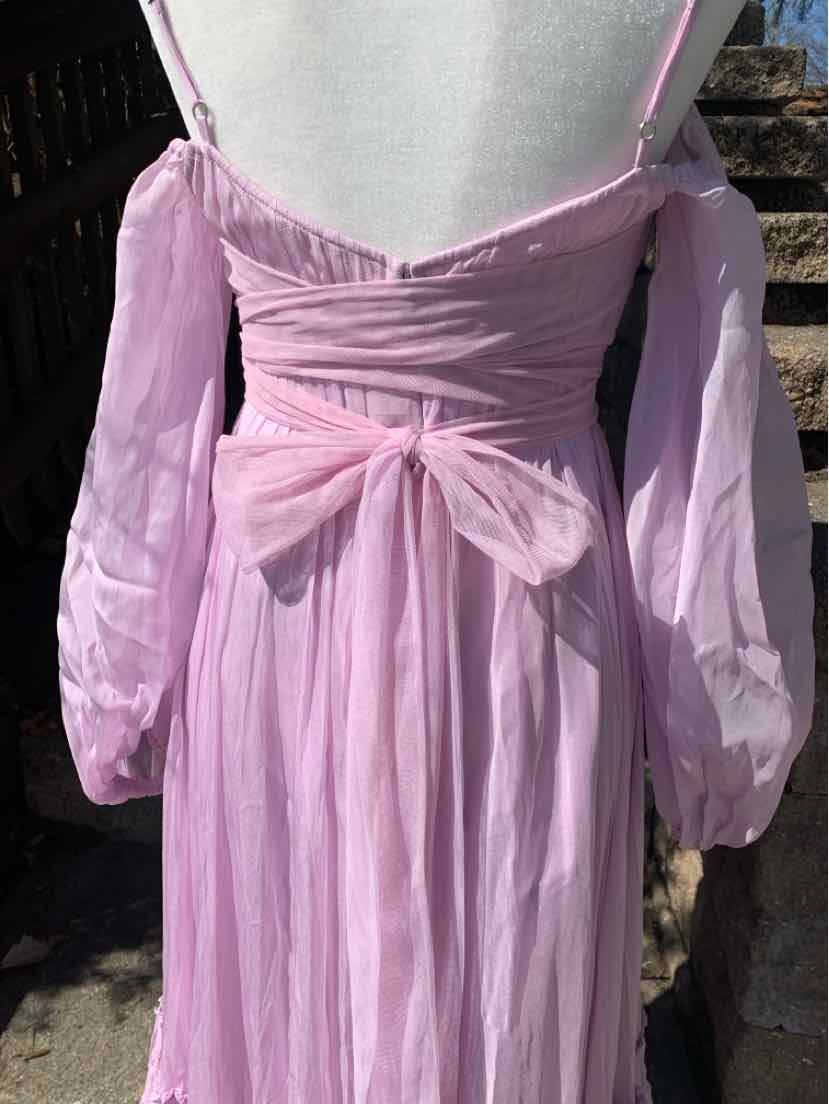 Light pink off-shoulder dress with puffed long sleeves and a tied bow at the waist.