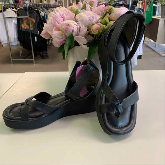 Black leather sandals with ankle straps, square toes, and low block heels, size 9.
