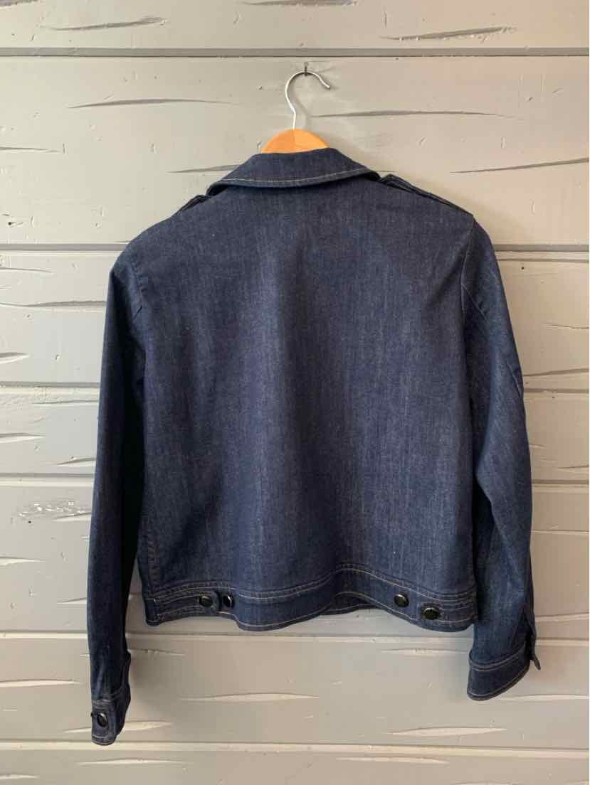 Dark navy denim jacket with buttoned waist tabs and long sleeves hanging on wooden hanger.