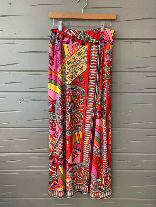 Colorful wide-leg pants with bold geometric and floral prints in red, pink, yellow, and orange hues.