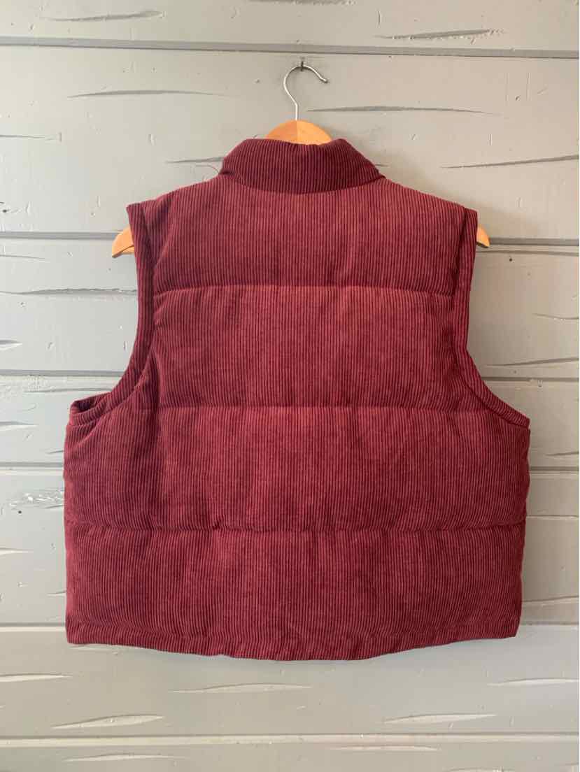 Women’s sleeveless quilted puffer vest in solid burgundy with high collar and boxy fit.