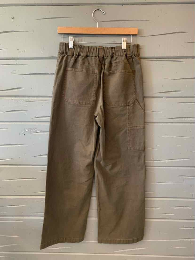 Olive green straight-leg pants with an elastic waistband, drawstring, and side pockets, hanging on a wooden hanger.