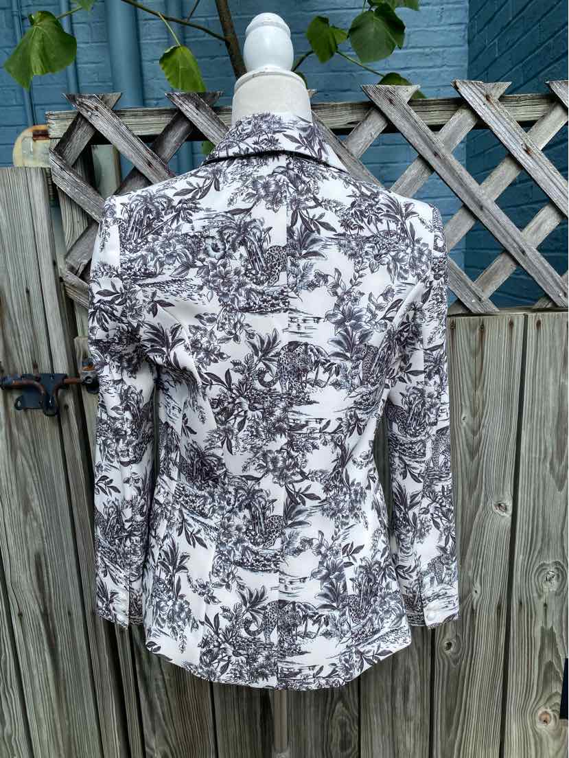 White blazer with black floral print, tailored fit, notch lapel collar, long sleeves, buttoned cuffs.