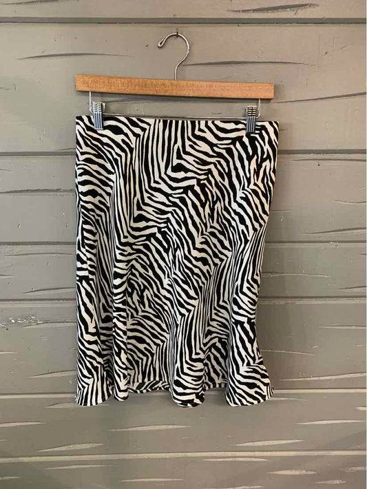 Black and white zebra stripe skirt with slight flare hem, size 4, hanging on wooden hanger.