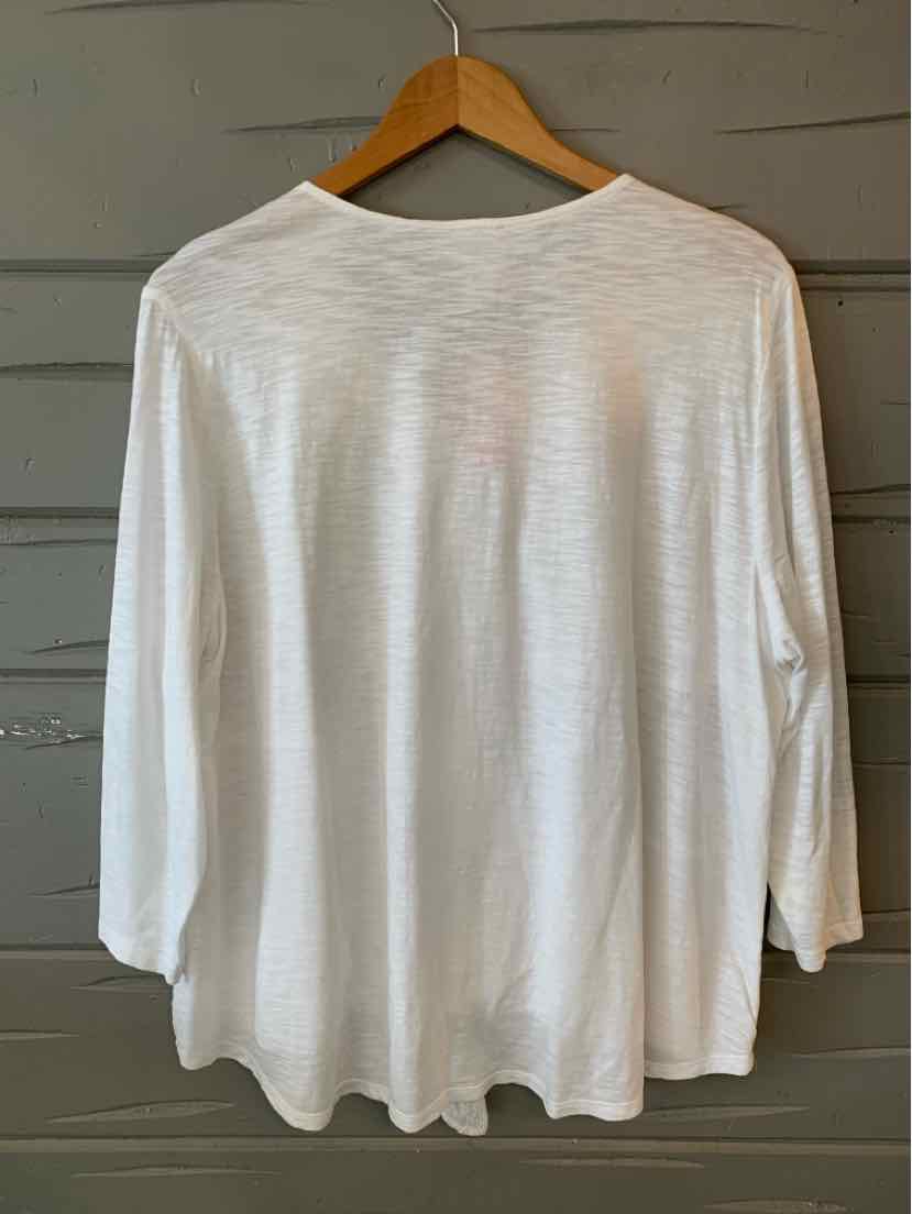 White long-sleeve lightweight blouse with round neckline on wooden hanger.