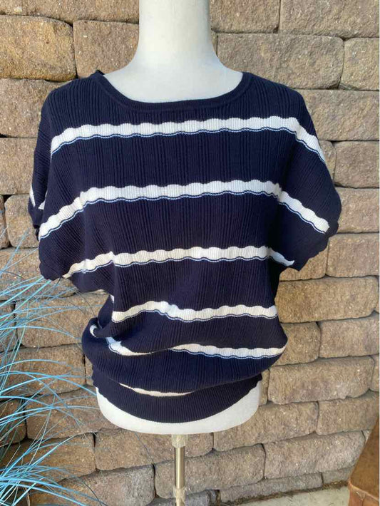 Navy blue short-sleeve blouse with white horizontal scalloped stripes and a rounded neckline.