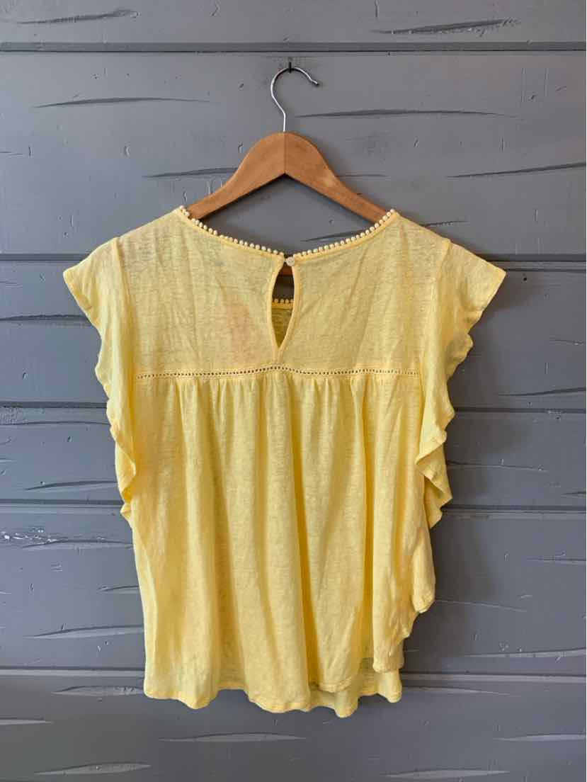 Light yellow short-sleeve blouse with ruffled sides and a small keyhole back button closure.