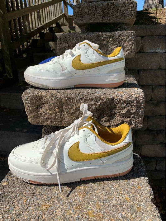 White Nike CR sneakers with mustard yellow swoosh and inner lining, size 8, solid design.