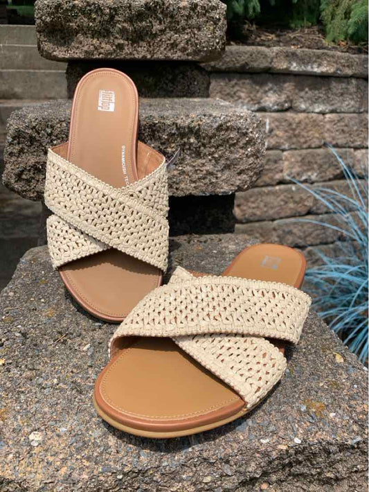 Tan woven raffia slide sandals with crisscross straps and cushioned footbed, size 8.