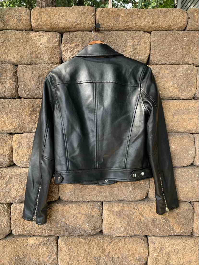 Black leather biker jacket with silver snap buttons and zippered cuffs, medium size.