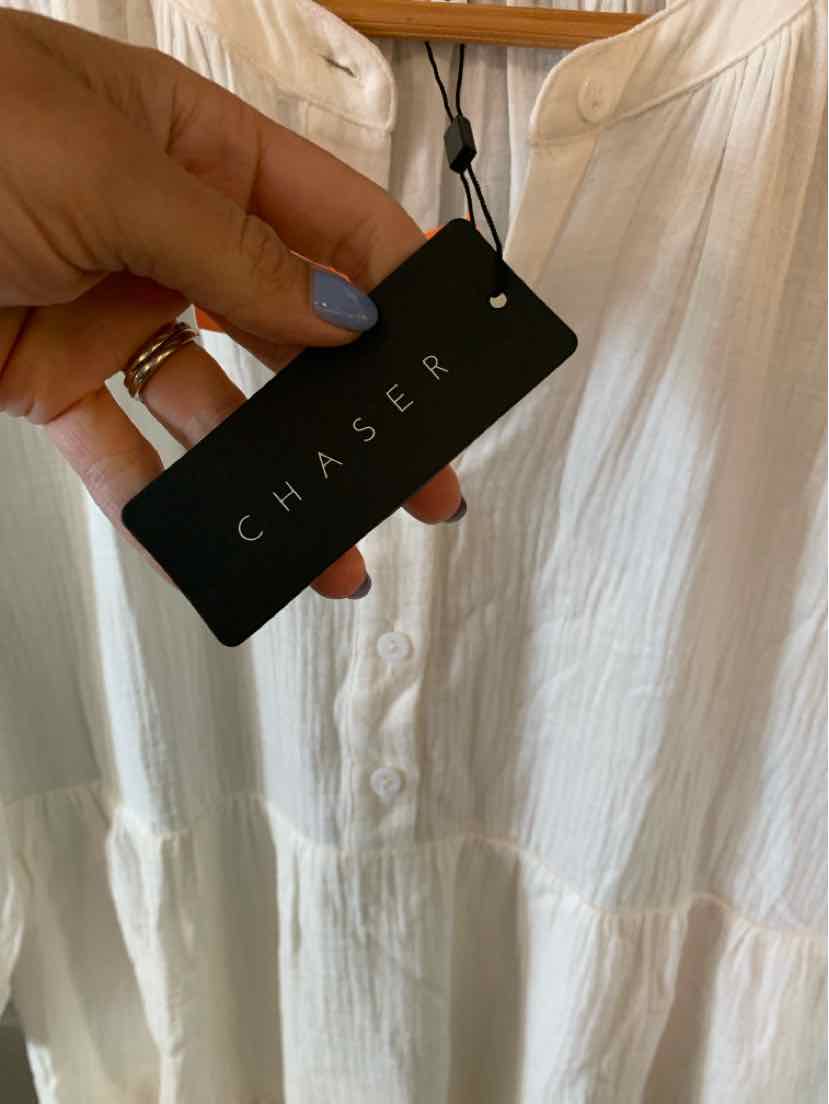 White lightweight dress with gathered waist and round neckline, featuring a black rectangular tag with "CHASER" in white.