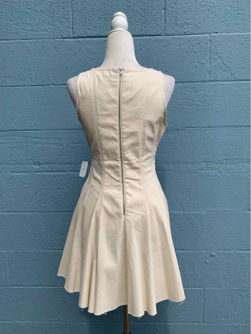Cream-colored sleeveless dress with fitted bodice and flared skirt, back zipper closure.