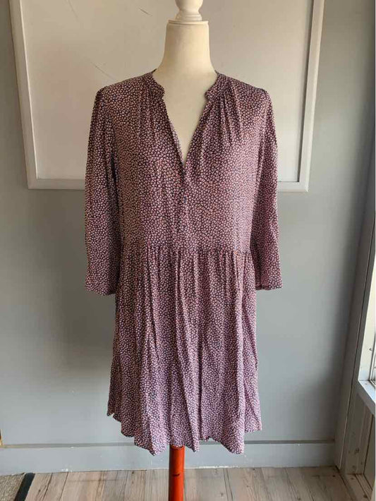 Blue patterned knee-length dress with long sleeves and V-neck on mannequin.
