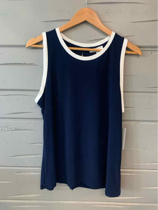 Navy blue sleeveless top with white trim around neckline and armholes hanging on wooden hanger.