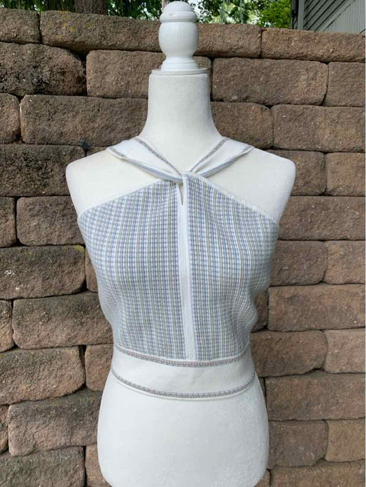 Light blue and white checkered knit halter top with crisscross straps and cropped fit on mannequin.
