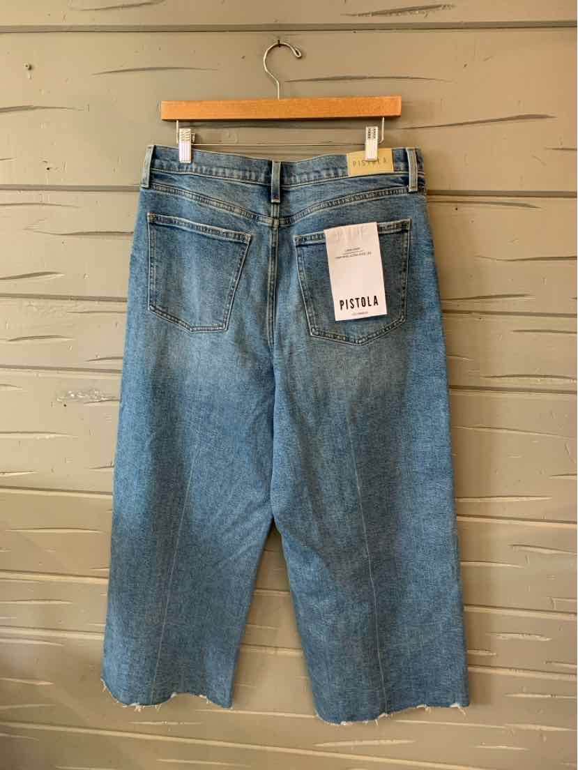Blue denim wide-leg jeans with back pockets and a white brand tag on the right pocket.