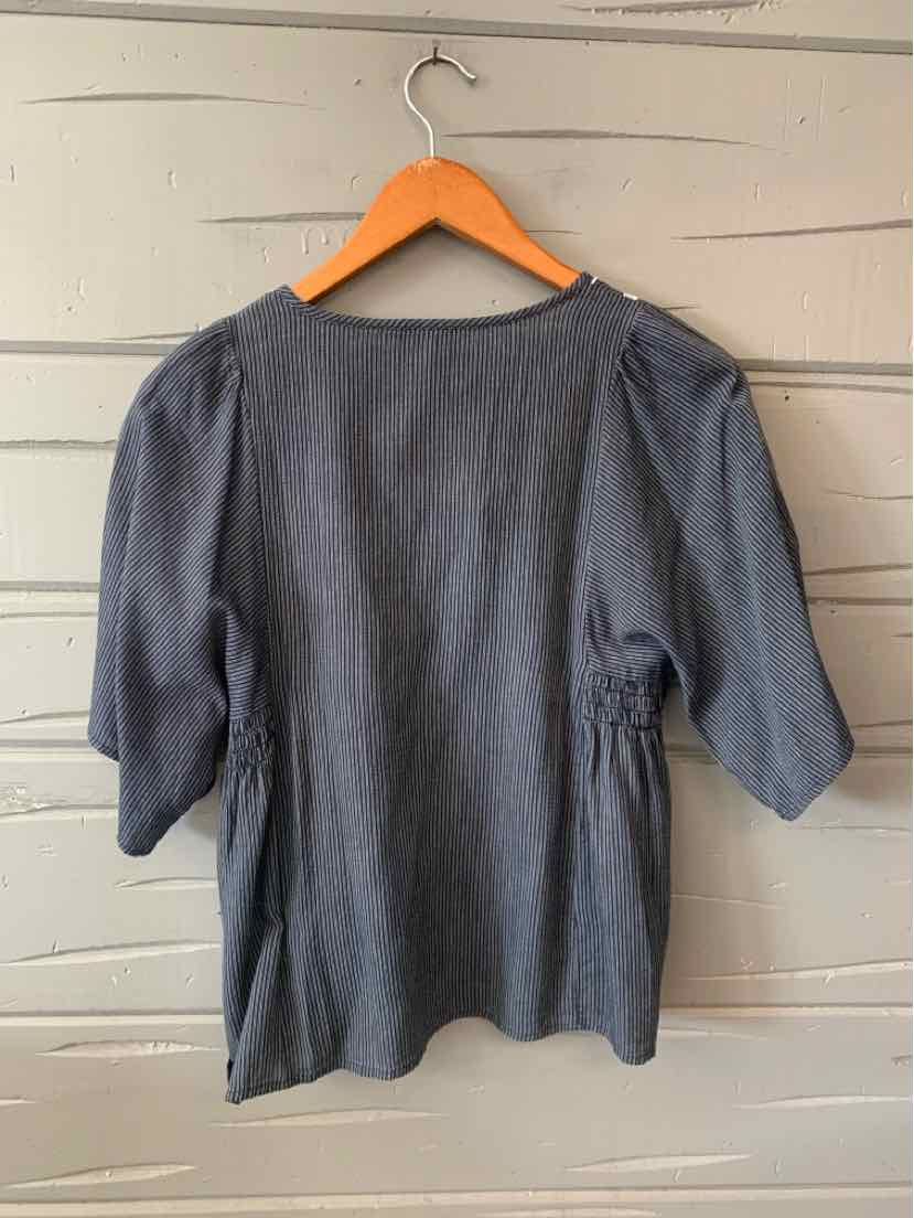 Dark gray striped blouse with short puff sleeves and a rounded neckline on wooden hanger.