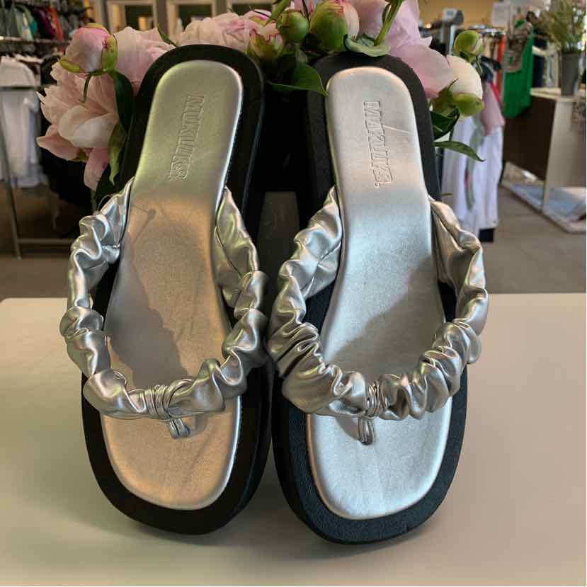 Silver ruched strap sandals with square black soles and cushioned footbeds.