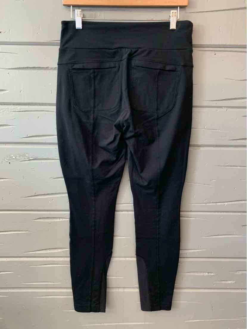 Black high-waisted athletic leggings with back pockets and a fitted ankle design.