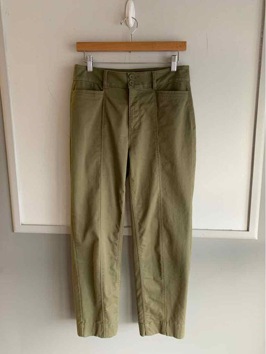 Olive green high-waist straight-leg pants with belt loops hanging on wooden hanger.