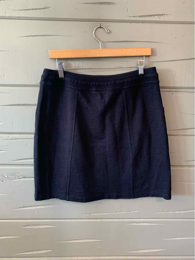 Black knee-length skirt with a straight cut and subtle seam details, hanging on a wooden hanger.