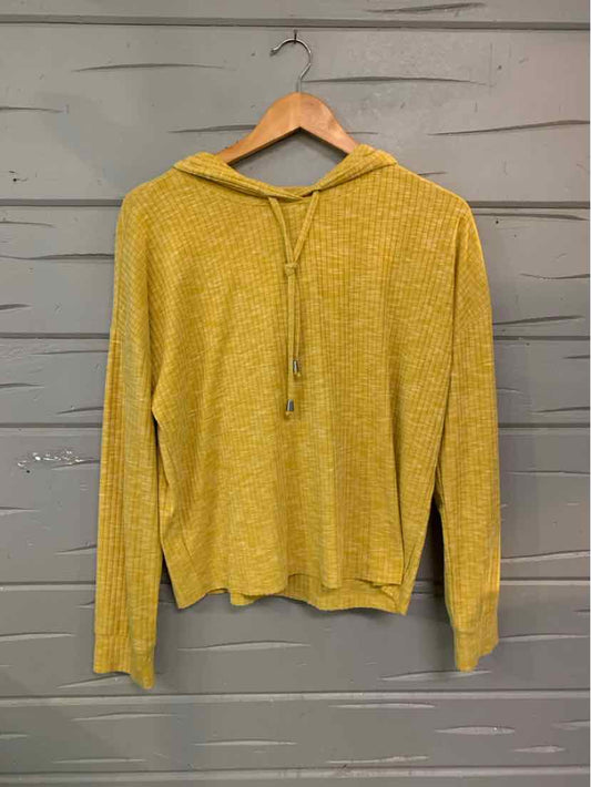 Lightweight yellow knit hoodie with long sleeves and drawstring hood on wooden hanger.