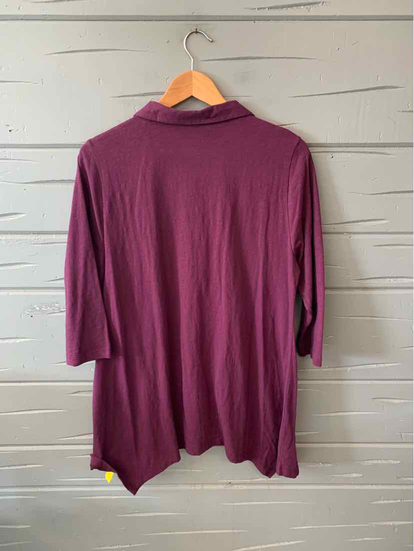 Long-sleeve plum purple tunic with relaxed fit and draped hem on wooden hanger.