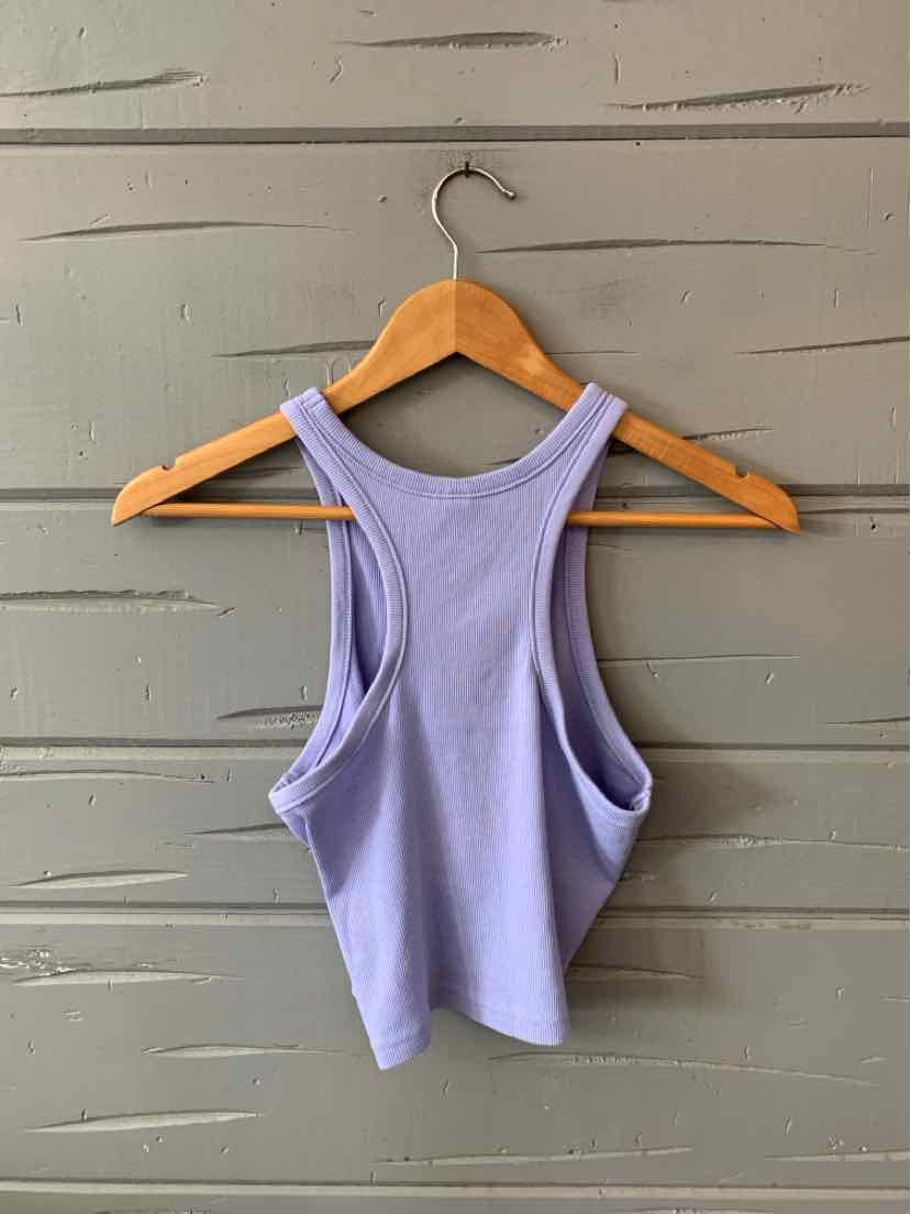Lavender sleeveless crop top with racerback design and ribbed texture hanging on wooden hanger.