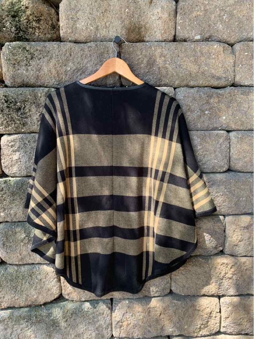 Black and beige plaid wool poncho with wide sleeves and a round neckline.