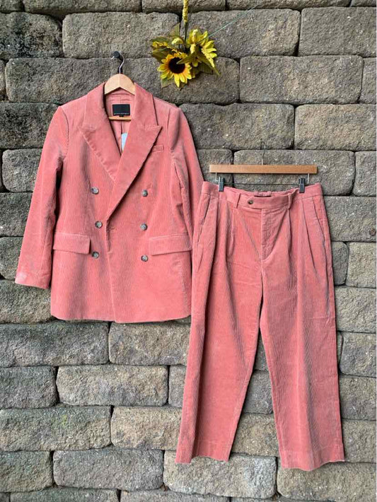 Pink corduroy two-piece suit with double-breasted blazer and tapered pants size 8.