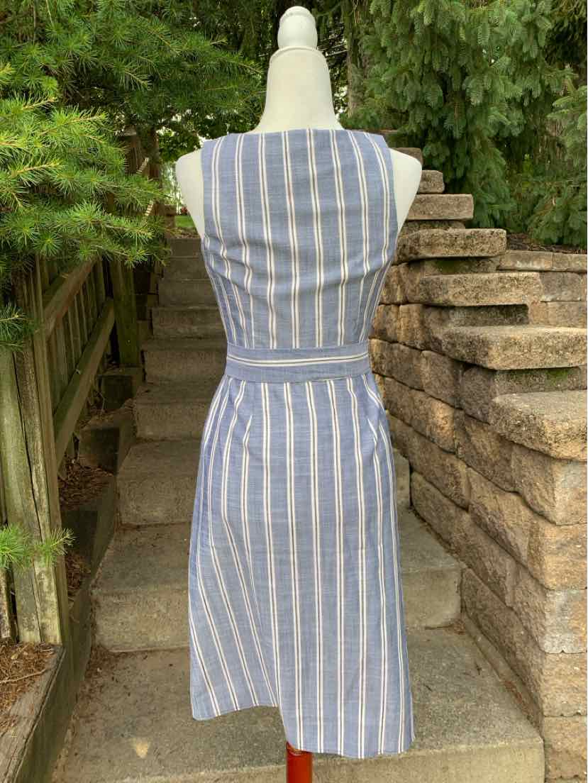 Blue and white vertical striped sleeveless midi dress with fitted waist and boat neckline.