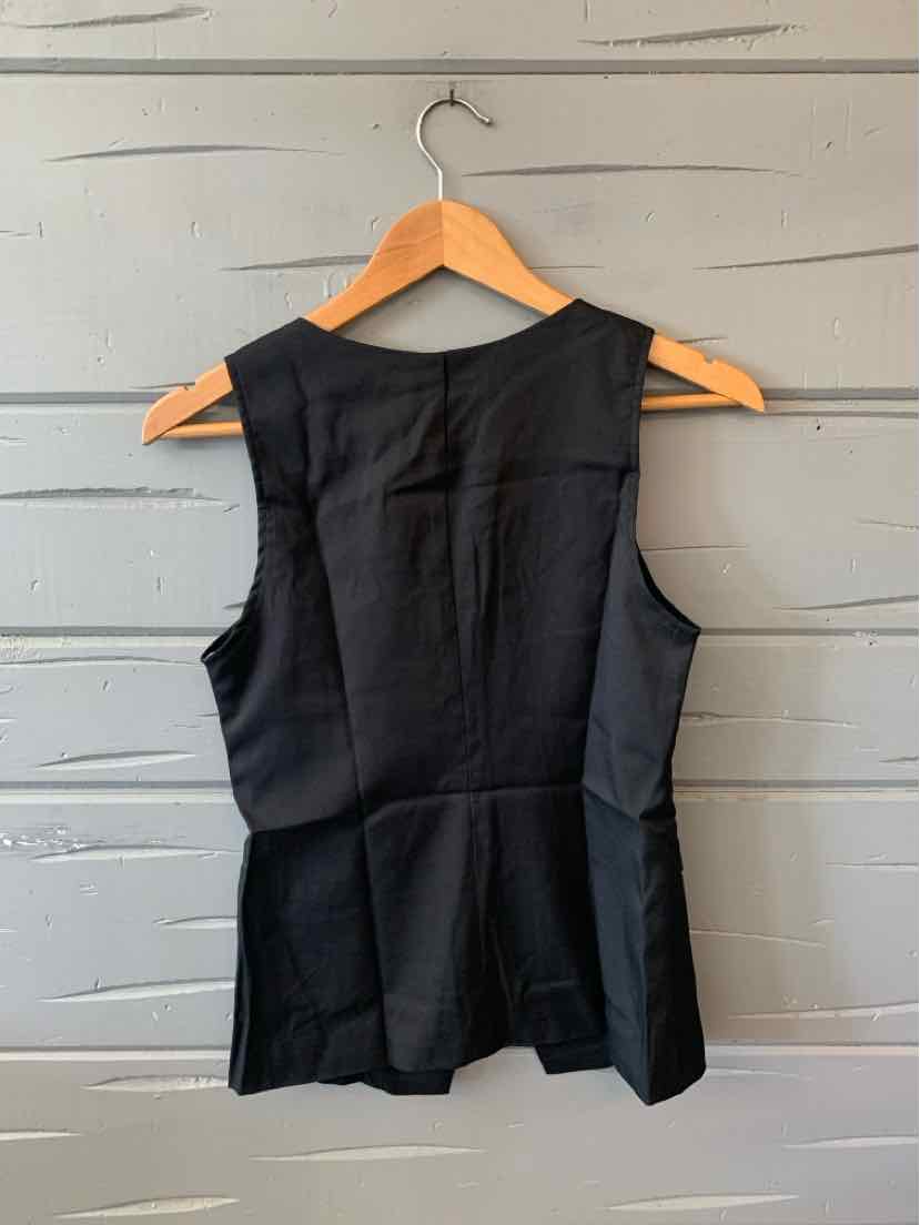 Black sleeveless vest with a structured fit and seam detailing, hanging on wooden hanger.