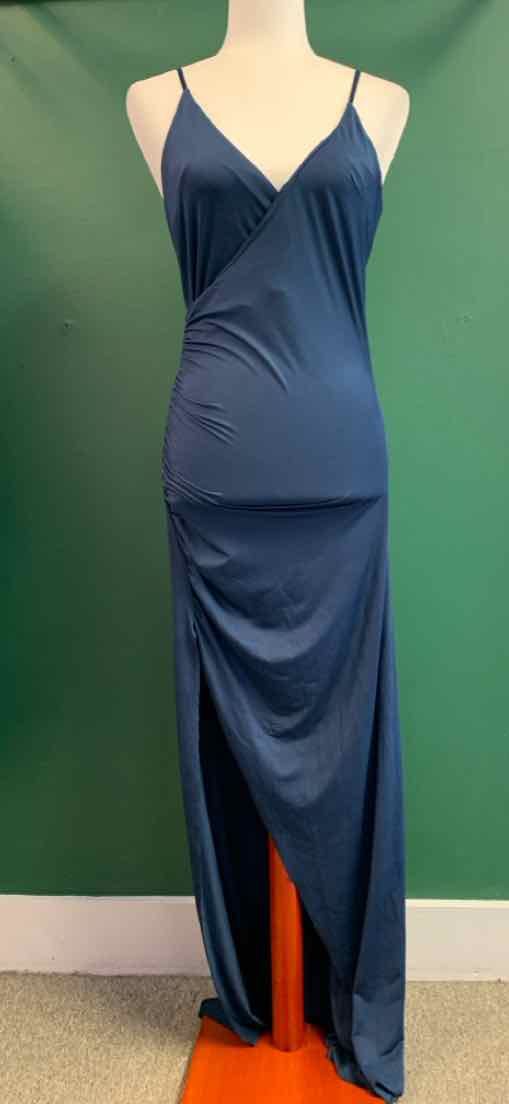 Navy blue sleeveless maxi dress with thin straps and side slit on mannequin.