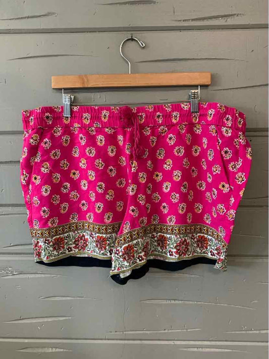 Pink floral shorts with white and yellow flower print and decorative patterned hem in XL size.