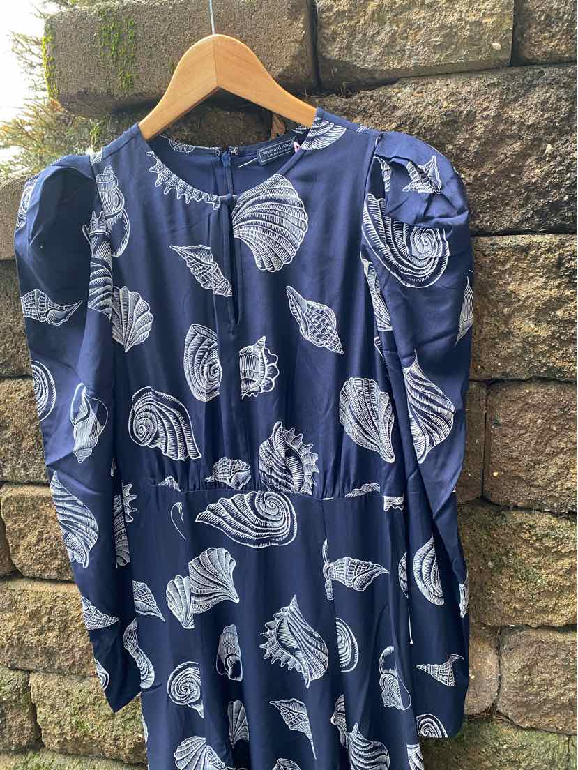 Navy blue dress with white seashell pattern, long puffed sleeves, round neckline, size 6.