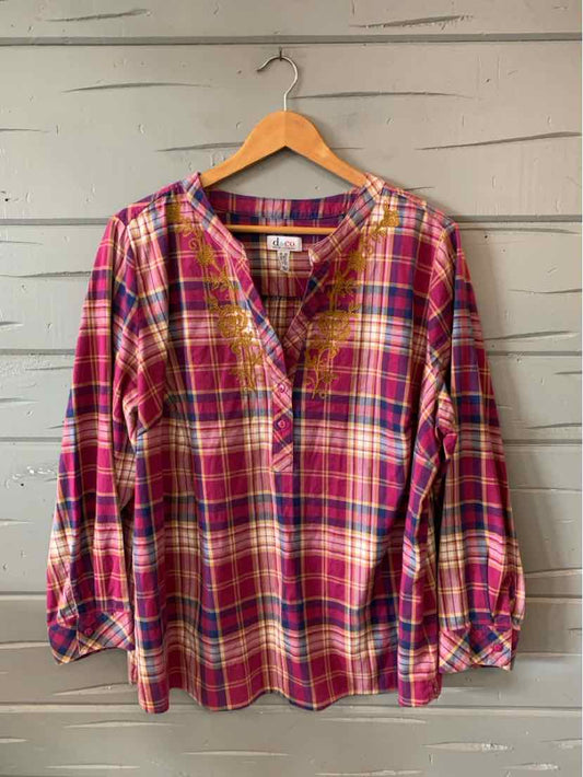 Long-sleeve women's plaid blouse in red, pink, and yellow with a round neckline and buttoned cuffs.