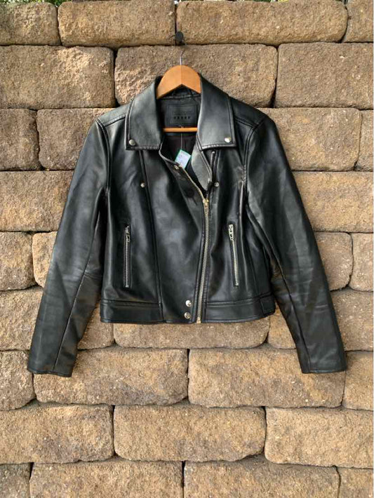 Black leather biker jacket with silver hardware, zippered pockets, and snap collar in medium size.