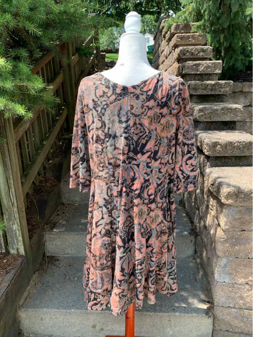 Flowy long-sleeve dress in muted earth tones with abstract floral pattern, knee-length, loose fit.