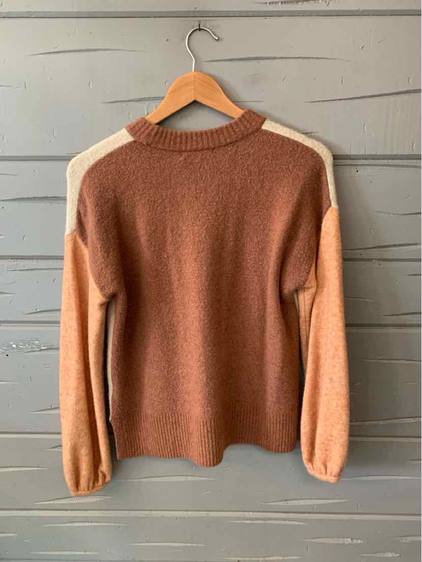 Color block knit sweater in warm brown, beige, and cream with a crew neck and long sleeves.