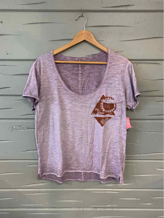 Light purple scoop neck short sleeve t-shirt with small brown graphic on left chest, relaxed fit.