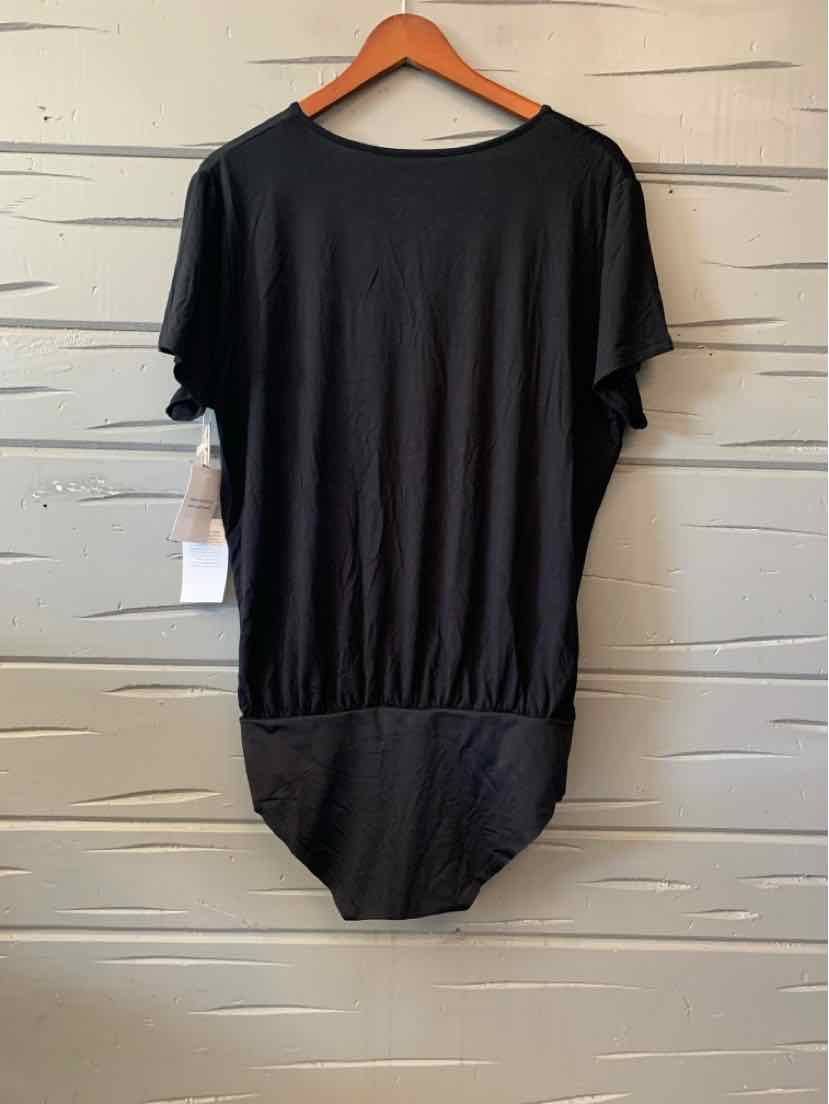 Black women's casual top with short sleeves and gathered hem hanging on wooden hanger.