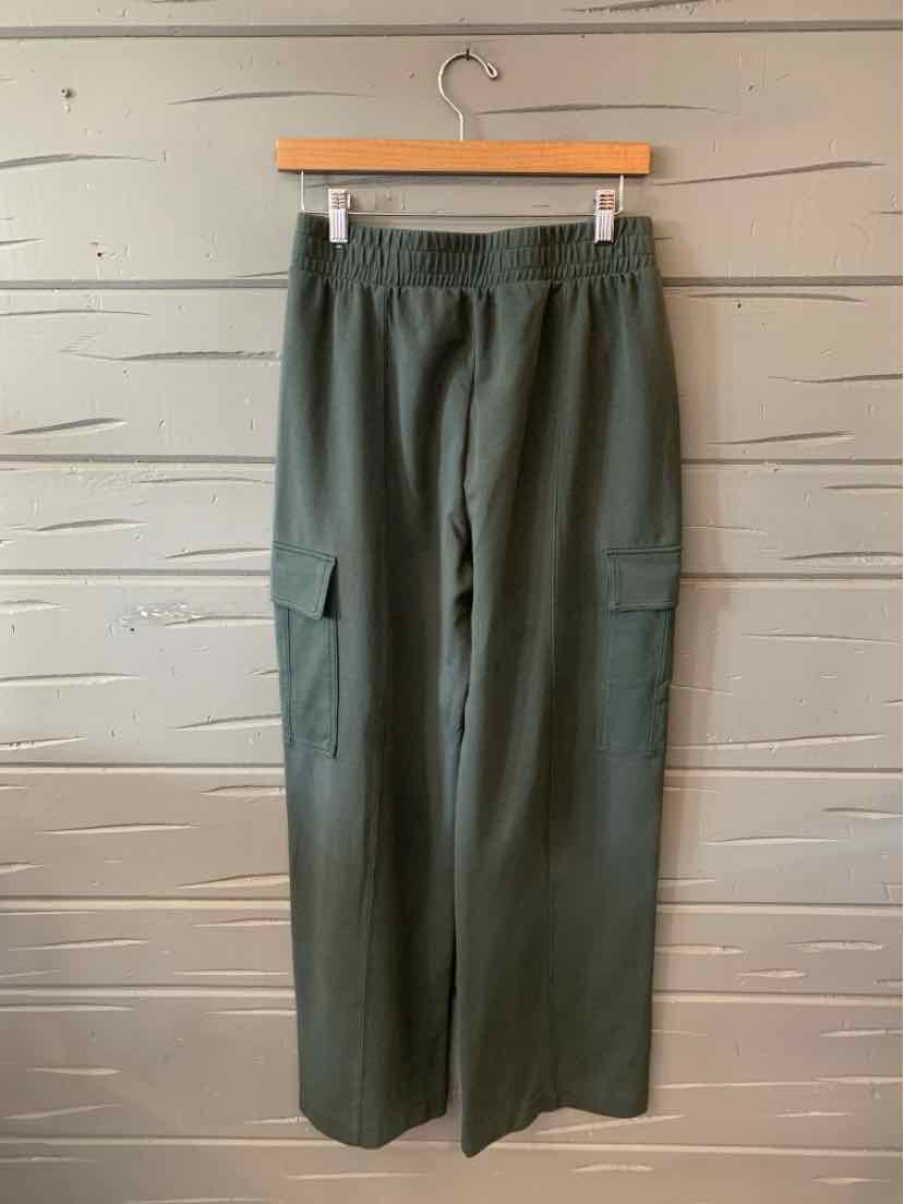 Olive green wide-leg cargo pants with elastic waistband and side flap pockets.